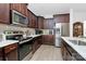 Well-equipped kitchen boasts stainless steel appliances, sleek dark cabinets, and marble countertops at 4213 Stockbrook Dr, Charlotte, NC 28215