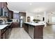 Modern kitchen featuring dark wood cabinets, stainless steel appliances, and an island with seating at 4213 Stockbrook Dr, Charlotte, NC 28215