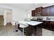 Kitchen island with marble countertops, sink, breakfast bar, and stainless steel appliances at 4213 Stockbrook Dr, Charlotte, NC 28215