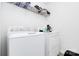 Functional laundry room with white washer and dryer, plus storage shelves for organization at 4213 Stockbrook Dr, Charlotte, NC 28215