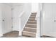 Bright staircase features carpet steps with white risers and frames, connecting two floors at 4213 Stockbrook Dr, Charlotte, NC 28215
