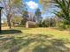 Large grassy backyard with a shed and partial fence in a suburban setting at 4331 Hamilton Cir, Charlotte, NC 28216