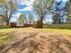 Spacious backyard featuring a barn, ample lawn, and secure fencing for outdoor enjoyment and storage at 4331 Hamilton Cir, Charlotte, NC 28216