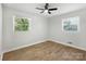 Bright, minimalist bedroom with hardwood floors and two windows for natural light at 4331 Hamilton Cir, Charlotte, NC 28216