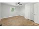 Bright bedroom features a ceiling fan, wood-look floors, and a closet at 4331 Hamilton Cir, Charlotte, NC 28216