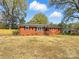 Charming brick home with mature trees, manicured landscaping, and a well-maintained front yard at 4331 Hamilton Cir, Charlotte, NC 28216