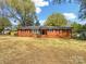 Charming brick home with mature trees, manicured landscaping, and a well-maintained front yard at 4331 Hamilton Cir, Charlotte, NC 28216