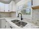 Modern kitchen with stylish countertops, backsplash, stainless steel sink and faucet at 4331 Hamilton Cir, Charlotte, NC 28216