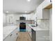 Modern kitchen featuring white cabinets, stainless steel appliances, and an island with a marble countertop at 4331 Hamilton Cir, Charlotte, NC 28216