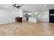 Open concept living room with hardwood flooring, fireplace, and a seamless flow to the kitchen at 4331 Hamilton Cir, Charlotte, NC 28216