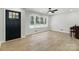 Bright living room features wood floors, large windows, and a modern ceiling fan at 4331 Hamilton Cir, Charlotte, NC 28216