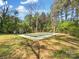 Inground pool with a green cover surrounded by mature trees and a grassy lawn at 4331 Hamilton Cir, Charlotte, NC 28216
