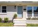 Exterior view of charming front entrance with light blue door, modern black sconce, and decorative plants at 4343 Dowling Dr, Charlotte, NC 28205