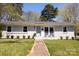 Charming painted brick home with a well-manicured lawn and inviting light blue front door at 4343 Dowling Dr, Charlotte, NC 28205