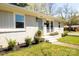 Brick home showcasing manicured landscaping and a light blue front door and white window frames at 4343 Dowling Dr, Charlotte, NC 28205
