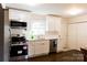 Updated kitchen with stainless steel appliances, white cabinets, and modern fixtures at 4343 Dowling Dr, Charlotte, NC 28205