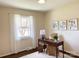 Bright home office with dark wood desk, neutral decor, large window, and hardwood floors at 4343 Dowling Dr, Charlotte, NC 28205