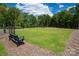 Community dog park with lush green grass, benches, and a secure fence at 5152 Tommy Ln # 1303, Stanley, NC 28164