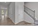 Hallway with wood floors, closet space, and carpeted stairs with iron railing at 5152 Tommy Ln # 1303, Stanley, NC 28164