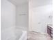 Bright bathroom featuring a soaking tub and a vanity with sink at 5670 Hammermill Dr, Harrisburg, NC 28075