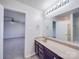 Well-lit bathroom with a large mirror and a view into an airy bedroom at 5670 Hammermill Dr, Harrisburg, NC 28075
