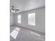 Neutral bedroom with two windows, a ceiling fan, and plush carpet at 5670 Hammermill Dr, Harrisburg, NC 28075
