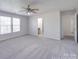 Bright bedroom with carpet, ceiling fan, and double windows providing natural light at 5670 Hammermill Dr, Harrisburg, NC 28075