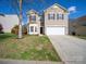 Charming two-story home with a well-maintained lawn and a two car garage at 5670 Hammermill Dr, Harrisburg, NC 28075