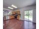 Bright kitchen features wood cabinets, stainless steel appliances, and sliding glass doors to a patio at 5670 Hammermill Dr, Harrisburg, NC 28075