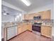Well-equipped kitchen with stainless steel appliances, granite counters, and wood cabinetry at 5670 Hammermill Dr, Harrisburg, NC 28075