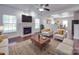 Bright living room featuring a fireplace, hardwood floors, and comfortable seating at 5670 Hammermill Dr, Harrisburg, NC 28075