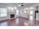 Open-concept living room with fireplace flows seamlessly into the adjacent kitchen at 5670 Hammermill Dr, Harrisburg, NC 28075