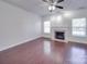 Spacious living room featuring a cozy fireplace, ceiling fan, and bright windows at 5670 Hammermill Dr, Harrisburg, NC 28075