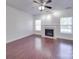 Inviting living room featuring a cozy fireplace, ceiling fan, and bright windows at 5670 Hammermill Dr, Harrisburg, NC 28075