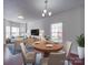 Open-concept dining and living area with hardwood floors and neutral decor at 5670 Hammermill Dr, Harrisburg, NC 28075