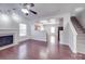 Open-concept living room with fireplace and stairs flowing to the upper levels at 5670 Hammermill Dr, Harrisburg, NC 28075