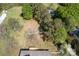 An aerial view shows a fenced yard with a wooden deck and a canopy of mature trees at 574 Pamela Rd, York, SC 29745