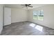 Light-filled bedroom with gray vinyl floors, ceiling fan, and white walls at 574 Pamela Rd, York, SC 29745