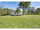 Charming single story home with green shutters, mature trees, and a large grassy yard at 574 Pamela Rd, York, SC 29745