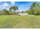 Single story home featuring green shutters, mature trees, large grassy yard, and white picket fence at 574 Pamela Rd, York, SC 29745
