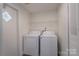 Functional laundry room with washer, dryer, wire shelving, and a utility door at 574 Pamela Rd, York, SC 29745