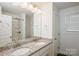 Granite countertop vanity with dual sinks in a well-lit bathroom at 5962 Charlie Walker Rd, Kannapolis, NC 28081