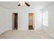 Bright bedroom with carpet, ceiling fan, closet, and ensuite bathroom at 5962 Charlie Walker Rd, Kannapolis, NC 28081