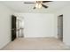 Spacious bedroom with carpet flooring, ceiling fan, and entry door at 5962 Charlie Walker Rd, Kannapolis, NC 28081