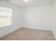 Carpeted bedroom with a window letting in natural light at 5962 Charlie Walker Rd, Kannapolis, NC 28081