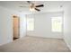 Bedroom featuring carpet flooring, ceiling fan and natural light from two windows at 5962 Charlie Walker Rd, Kannapolis, NC 28081