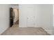 Neutral-toned bedroom with open doorway and carpeted floor at 5962 Charlie Walker Rd, Kannapolis, NC 28081