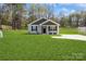 Beautiful single story home with manicured lawn and driveway leading to a detached storage building at 5962 Charlie Walker Rd, Kannapolis, NC 28081