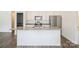 Kitchen island featuring sink, granite countertops, and a view into the adjacent rooms at 5962 Charlie Walker Rd, Kannapolis, NC 28081