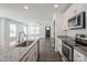 Bright kitchen featuring an island with a sink, granite countertops, and stainless steel appliances at 5962 Charlie Walker Rd, Kannapolis, NC 28081